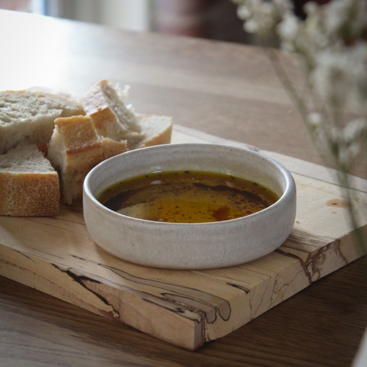 Bowl of dipping oil with some bread