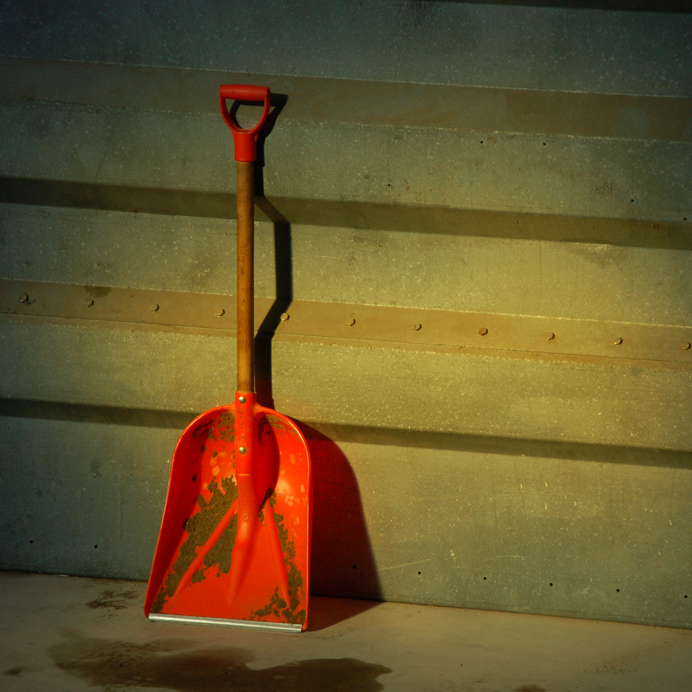 Shovel leaning against a wall